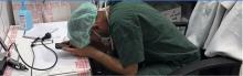 An overwhelmed medical worker in Gaza rests his head in his hands. Photo by Médecins Sans Frontières