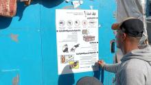  HI is putting up posters in camps for displaced people, explaining how best to protect oneself in the case of bombings and shellings, Khan Younis, Gaza Strip. | © HI